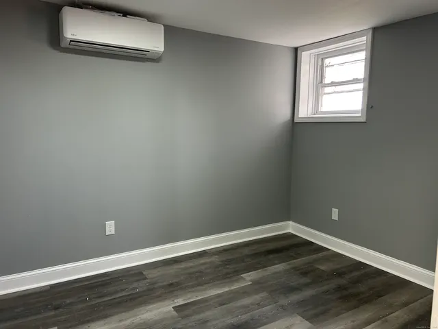 a view of a room with wooden floor and a window