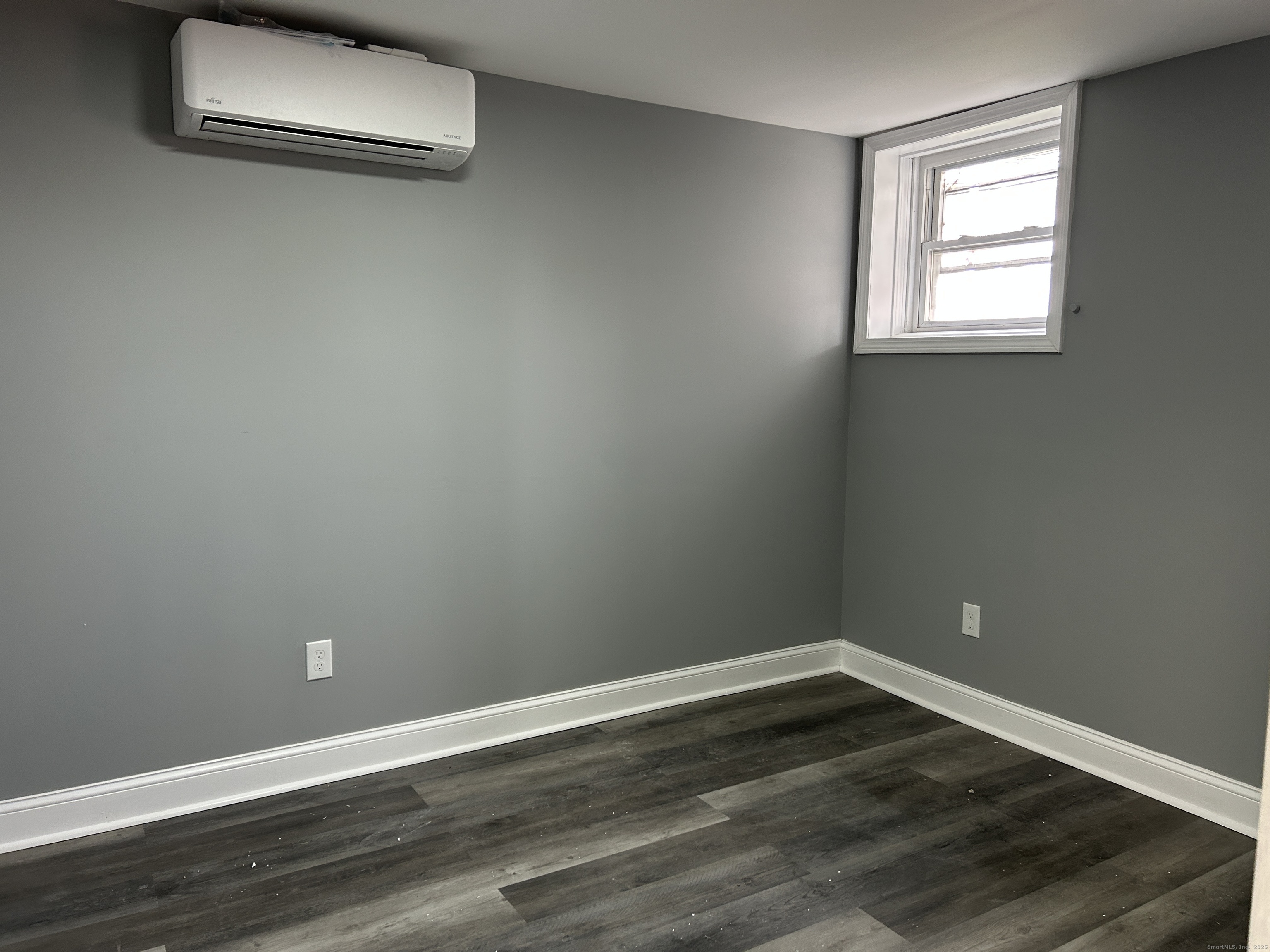 22 Hawthorne Street, Unit 1 Norwich, CT 06360 - Photo 17 of 22 a view of a room with wooden floor and a window
