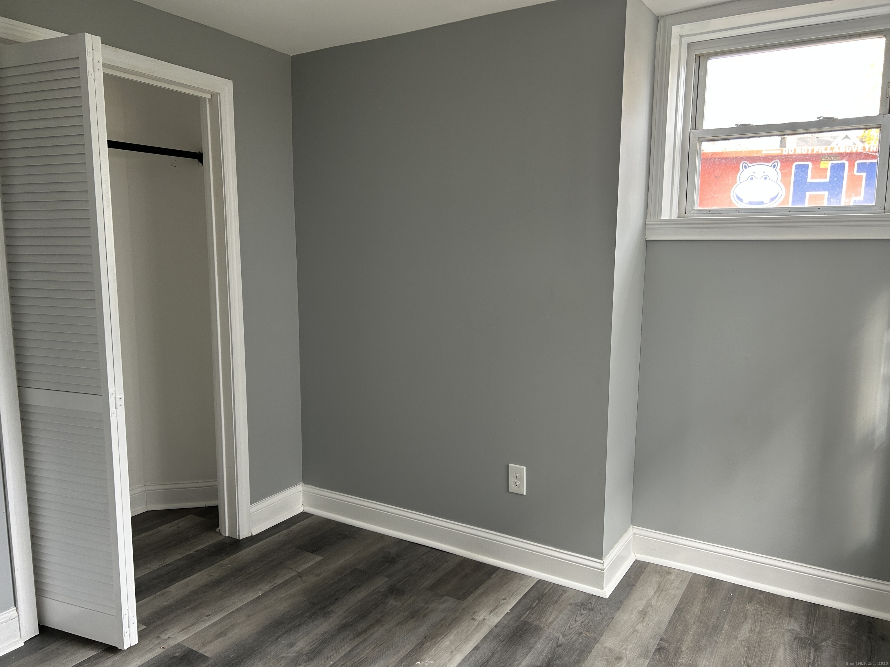 22 Hawthorne Street, Unit 1 Norwich, CT 06360 - Photo 20 of 22 an empty room with wooden floor and windows