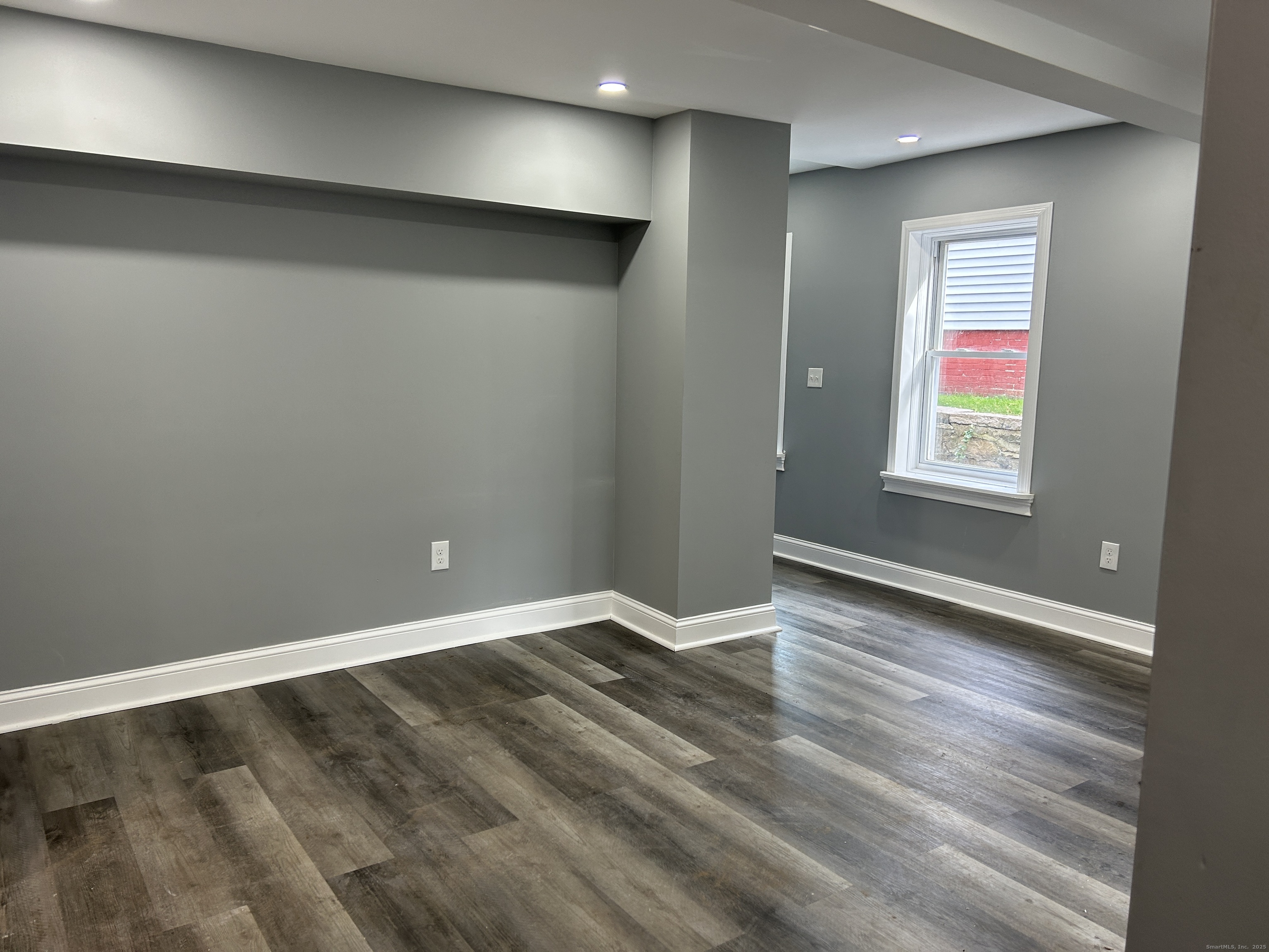 22 Hawthorne Street, Unit 1 Norwich, CT 06360 - Photo 3 of 22 an empty room with wooden floor and windows