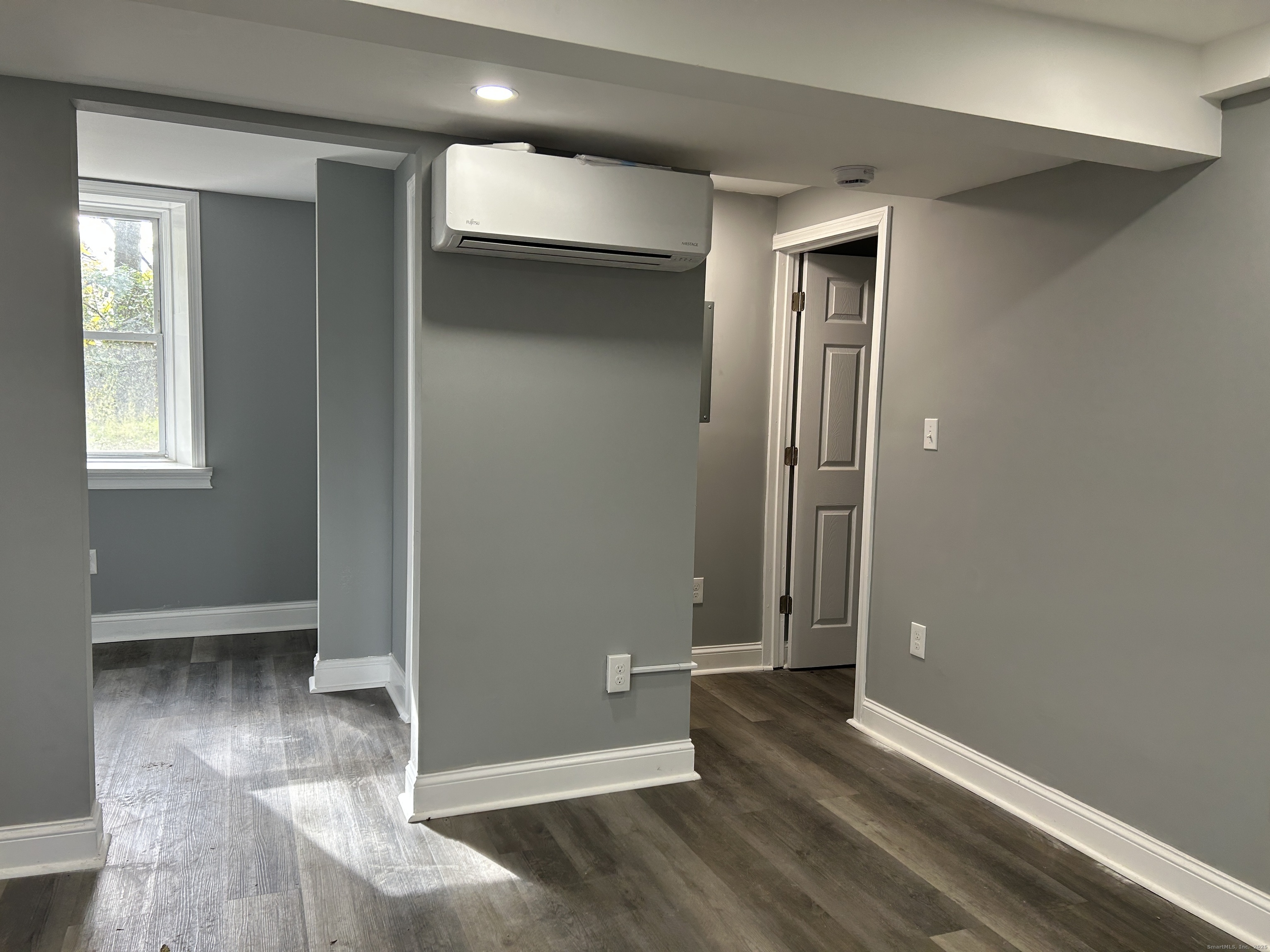 22 Hawthorne Street, Unit 1 Norwich, CT 06360 - Photo 4 of 22 an empty room with wooden floor and windows