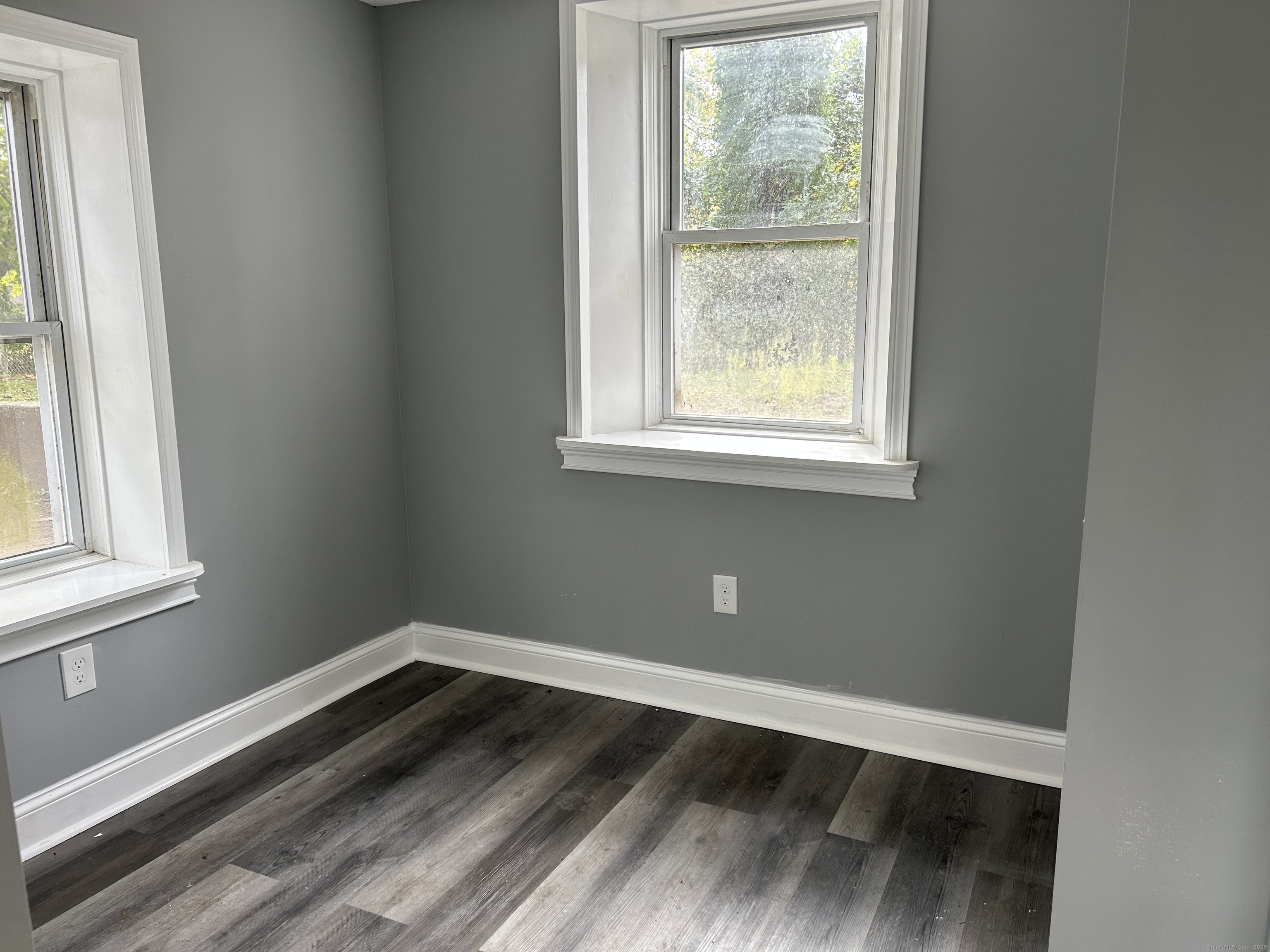 22 Hawthorne Street, Unit 1 Norwich, CT 06360 - Photo 8 of 22 an empty room with wooden floor and windows