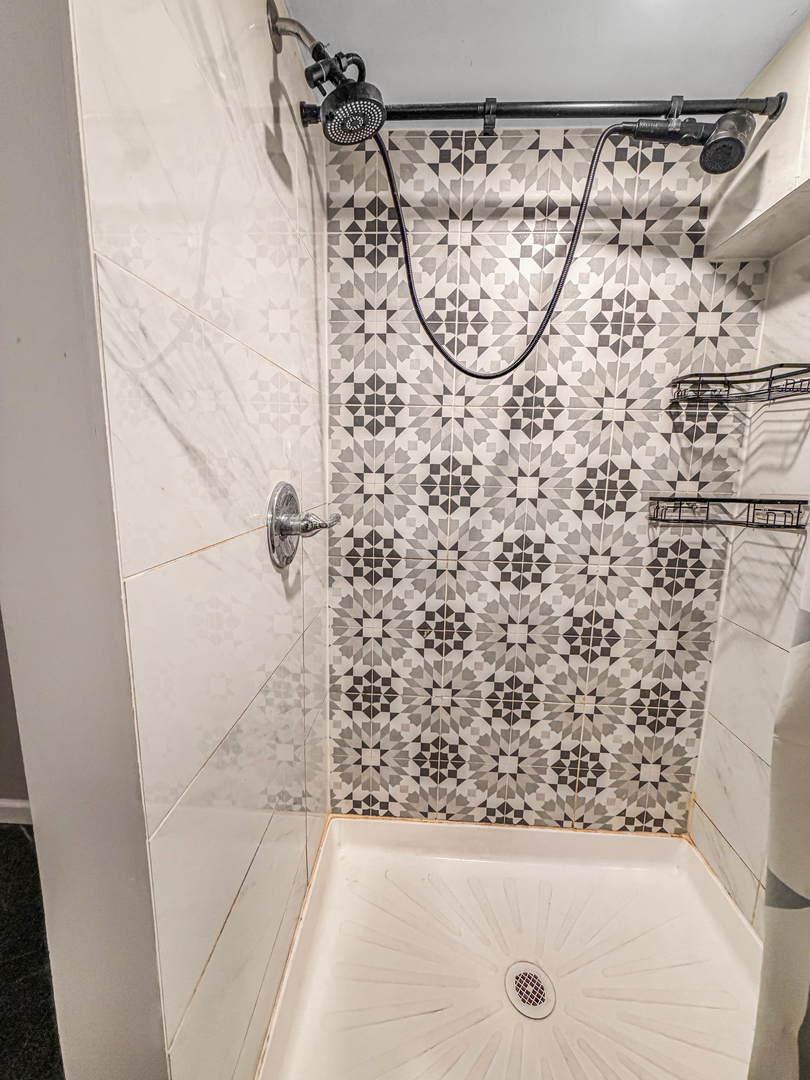 7241 Beloit Avenue Bridgeview, IL 60455 - Photo 22 of 26 a bathroom with a shower and a sink