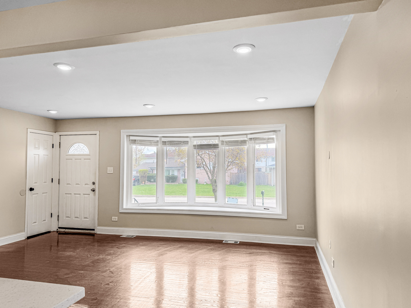 7241 Beloit Avenue Bridgeview, IL 60455 - Photo 5 of 26 a view of an empty room with wooden floor and a window