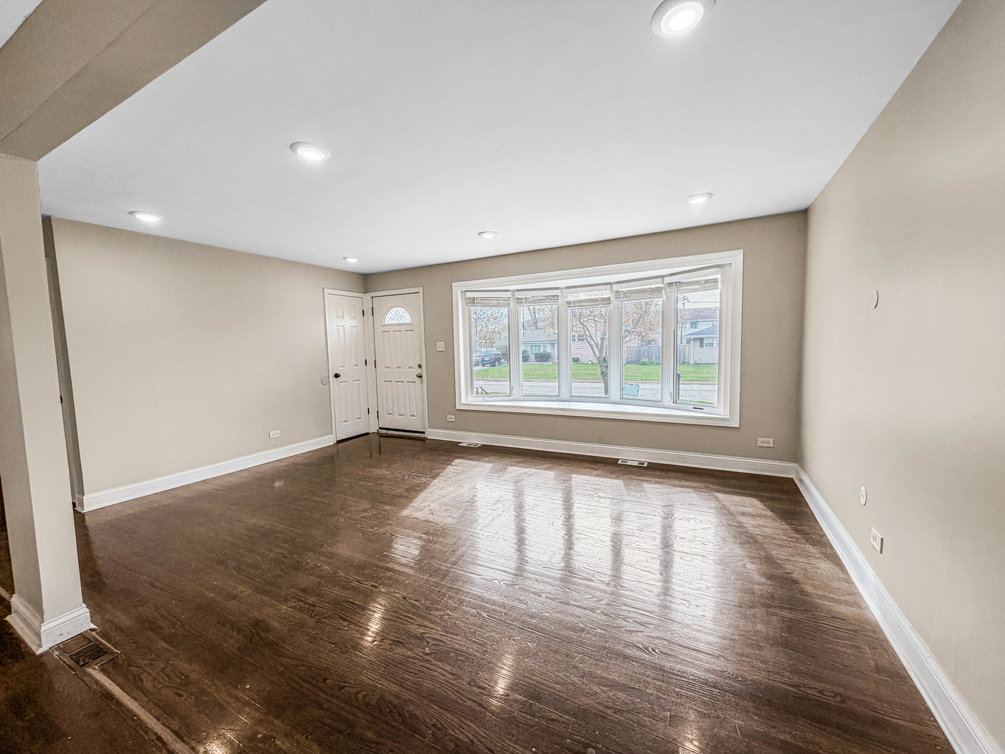 7241 Beloit Avenue Bridgeview, IL 60455 - Photo 9 of 26 an empty room with wooden floor and windows
