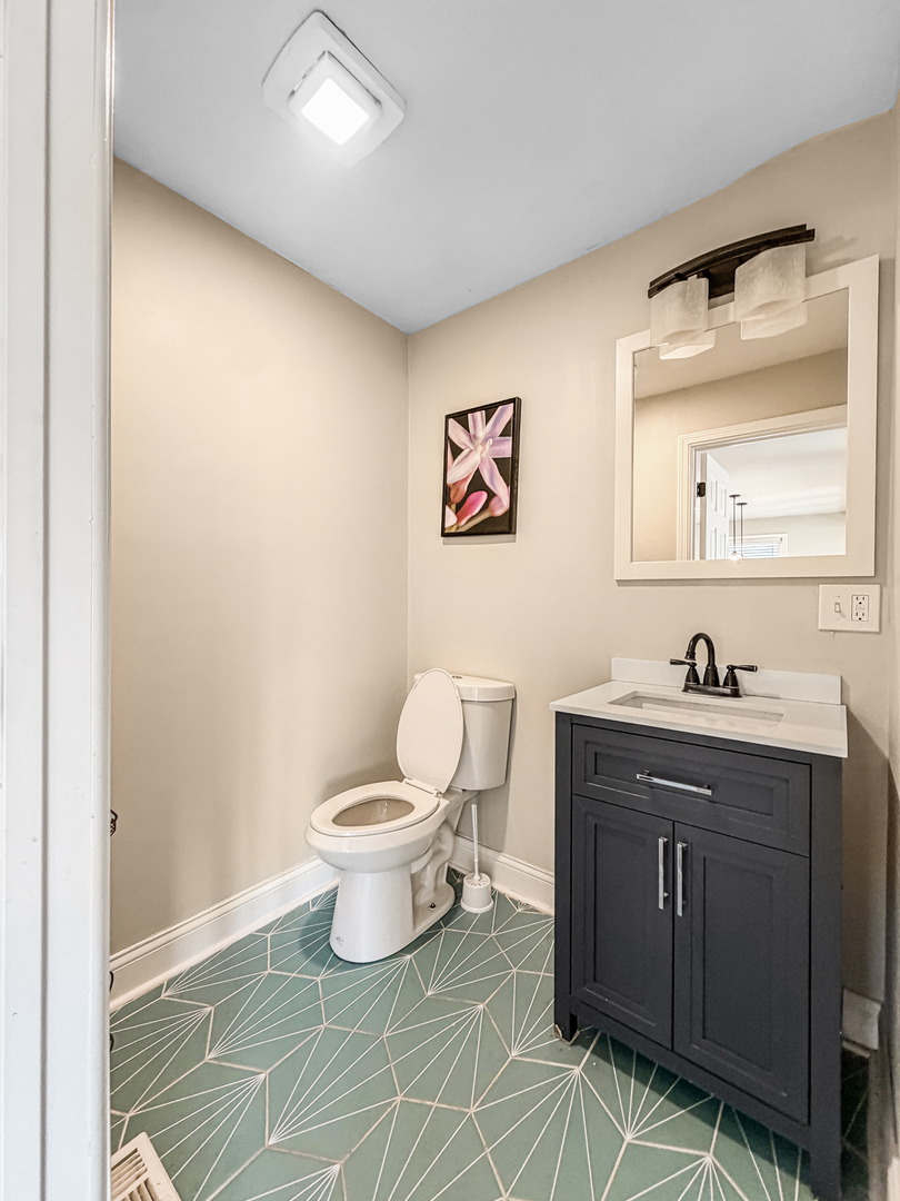 7241 Beloit Avenue Bridgeview, IL 60455 - Photo 10 of 26 a bathroom with a toilet sink and mirror