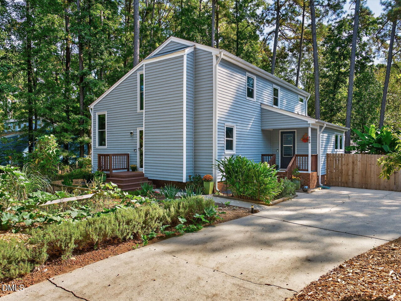 509 Holtz Lane Cary, NC 27511 - Photo 1 of 42 a view of backyard of house with potted plants