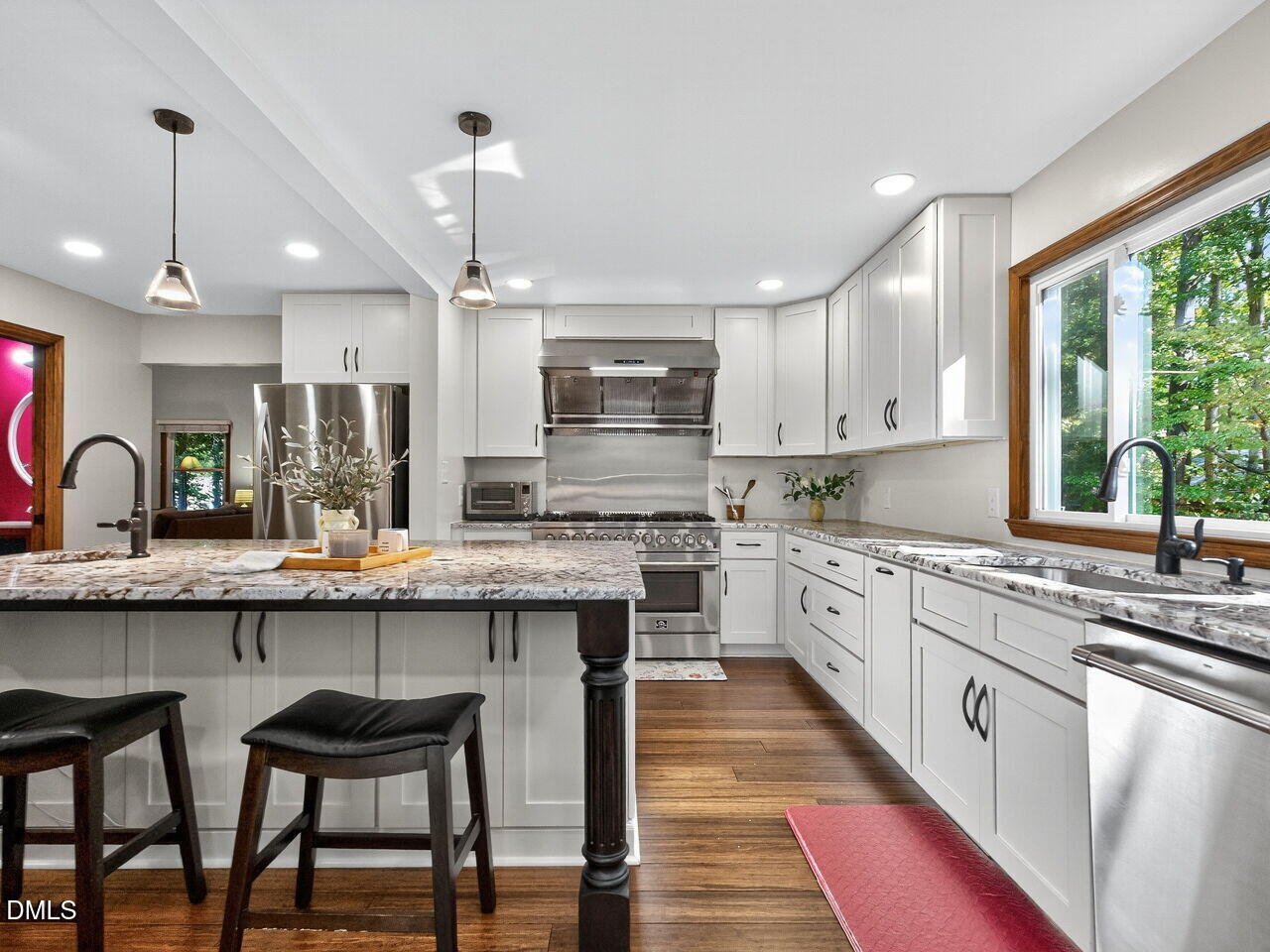 509 Holtz Lane Cary, NC 27511 - Photo 11 of 42 a kitchen with granite countertop white cabinets and stainless steel appliances