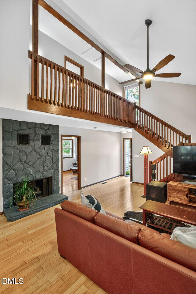 509 Holtz Lane Cary, NC 27511 - Photo 15 of 42 a living room with furniture a fireplace and a ceiling fan
