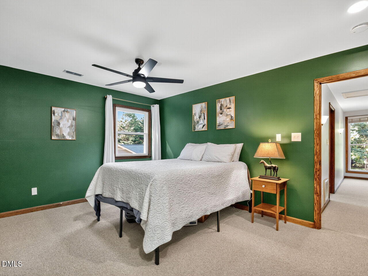 509 Holtz Lane Cary, NC 27511 - Photo 22 of 42 a bedroom with a bed and a chandelier