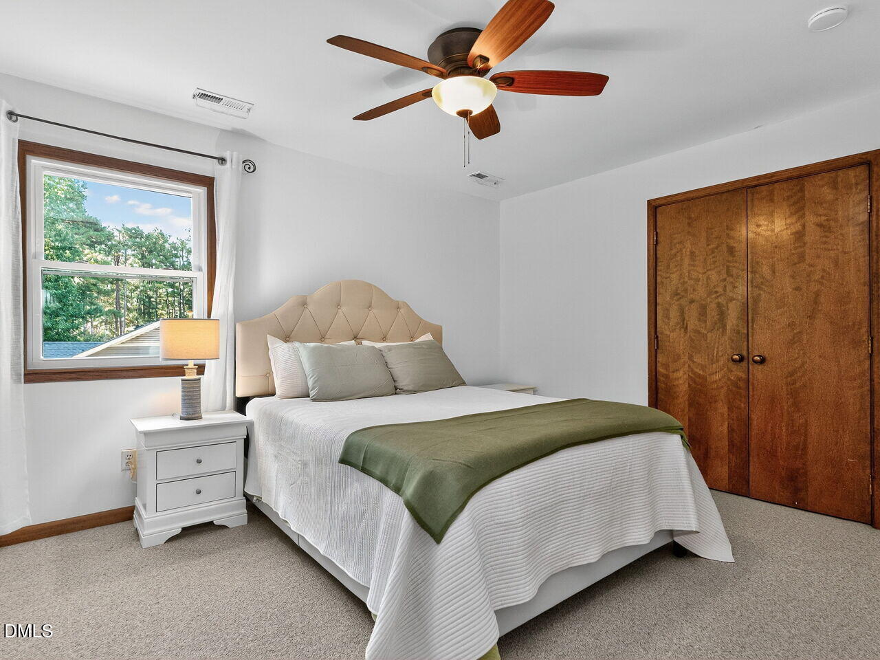 509 Holtz Lane Cary, NC 27511 - Photo 27 of 42 a bedroom with a bed and a chandelier