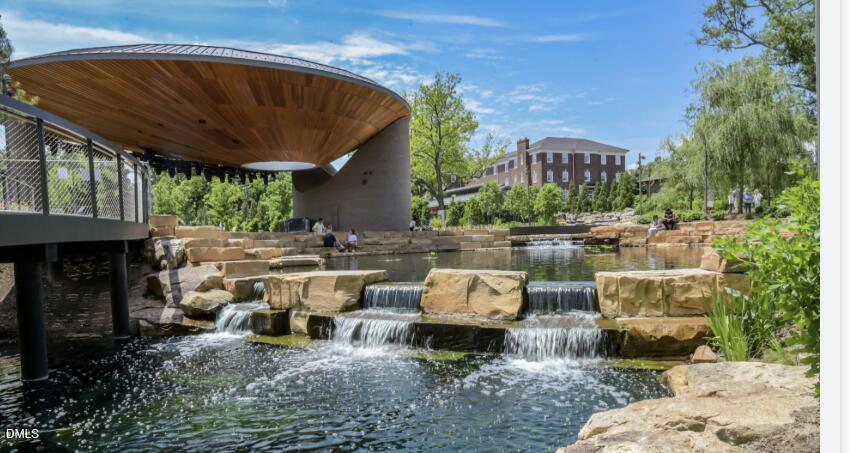 509 Holtz Lane Cary, NC 27511 - Photo 41 of 42 a view of a patio with table and chairs potted plants and a large tree