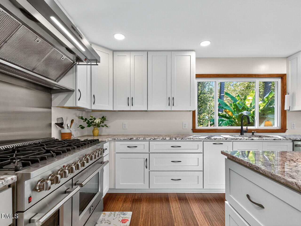 509 Holtz Lane Cary, NC 27511 - Photo 7 of 42 a kitchen with a stove a sink and wooden cabinets