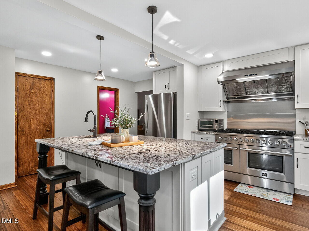 509 Holtz Lane Cary, NC 27511 - Photo 8 of 42 a kitchen with a stove a refrigerator and a wooden floor