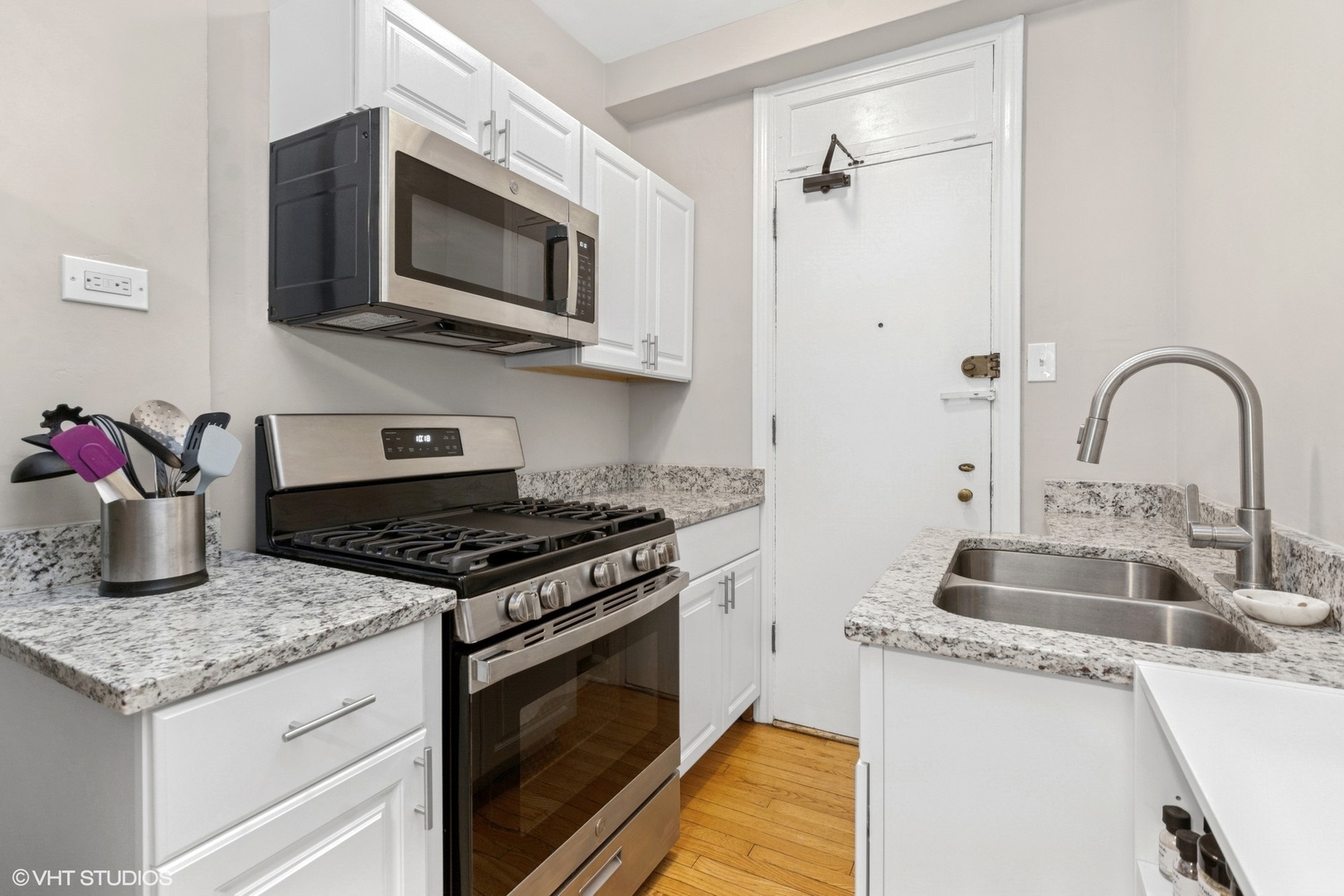 6334 North Sheridan Road, Unit 1D Chicago, IL 60660 - Photo 9 of 15 a kitchen with granite countertop a sink stainless steel appliances and cabinets