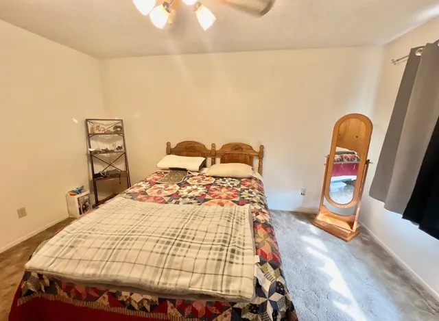 a bedroom with bed and a window