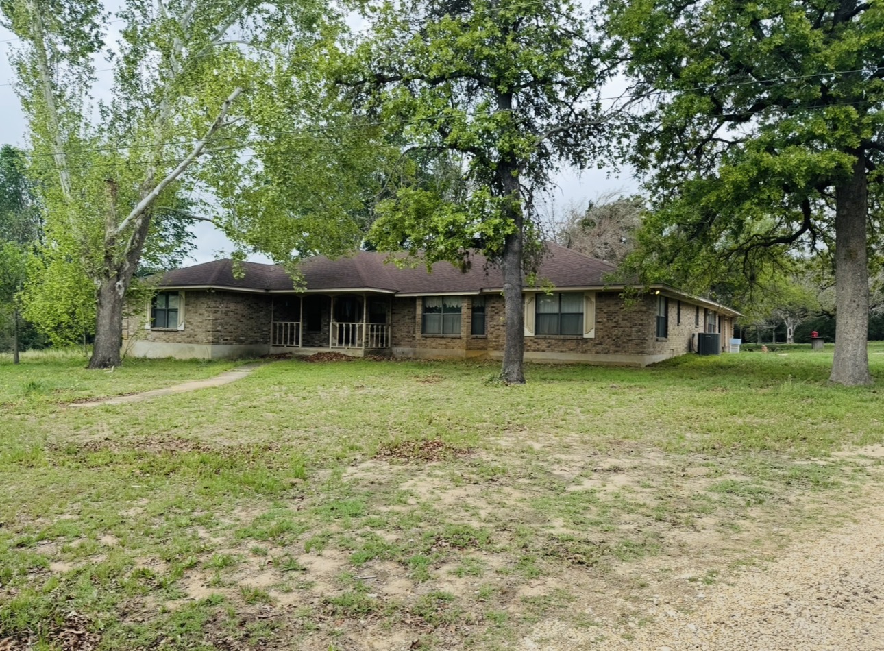 2410 State Highway 95 Elgin, TX 78621 - Photo 34 of 38 a front view of a house with a garden