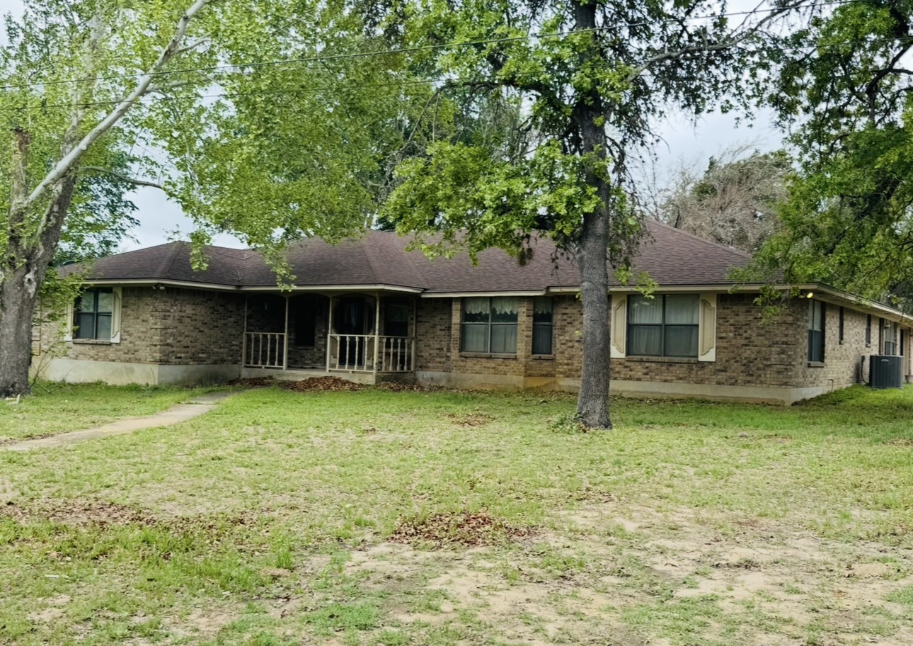 2410 State Highway 95 Elgin, TX 78621 - Photo 8 of 38 a front view of a house with a garden