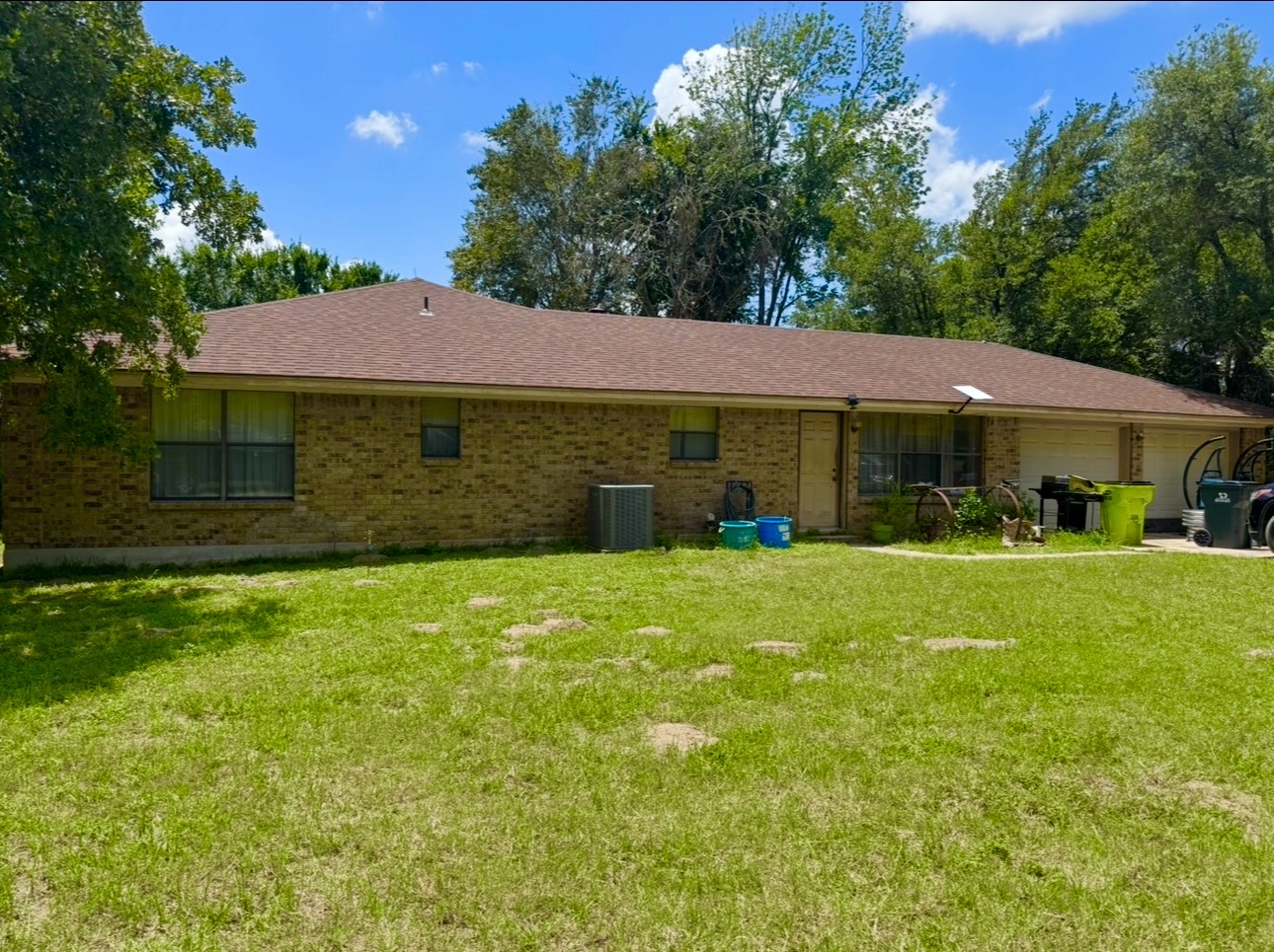 2410 State Highway 95 Elgin, TX 78621 - Photo 9 of 38 a front view of a house with a garden