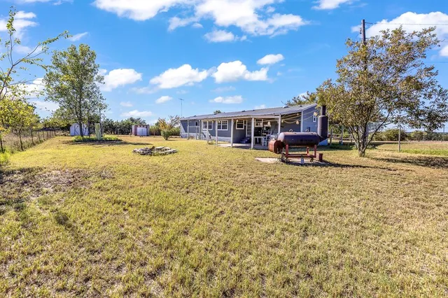 a view of a house with pool and sitting area