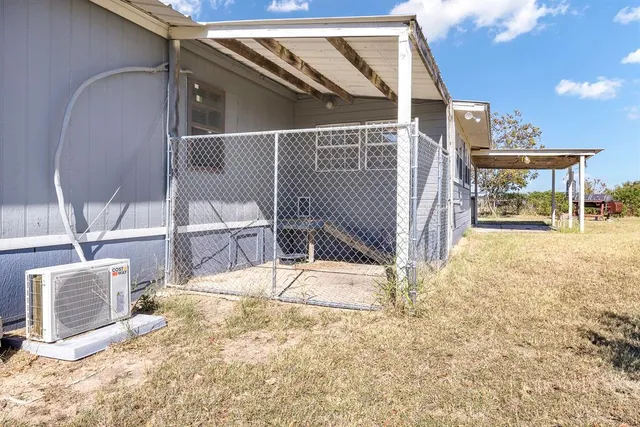 a view of a patio with table and chairs