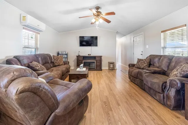 a living room with furniture fireplace and a window