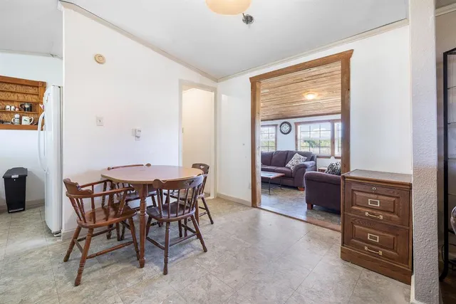 a view of a livingroom with furniture and a window