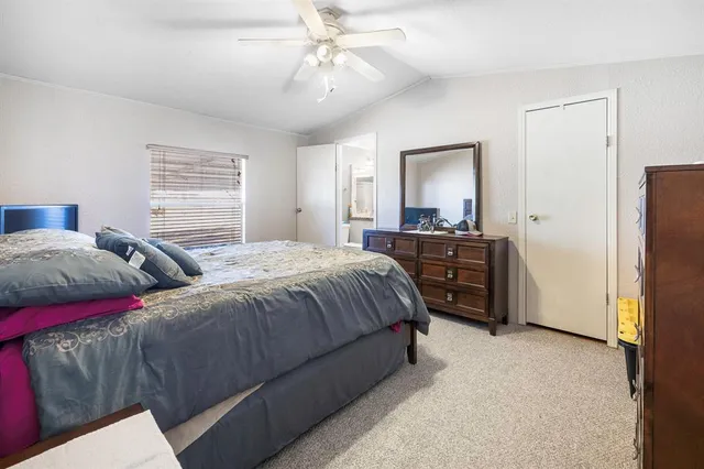 a spacious bedroom with two beds and a chandelier