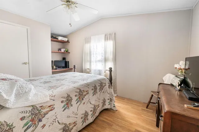 a bedroom with a bed and a desk chair