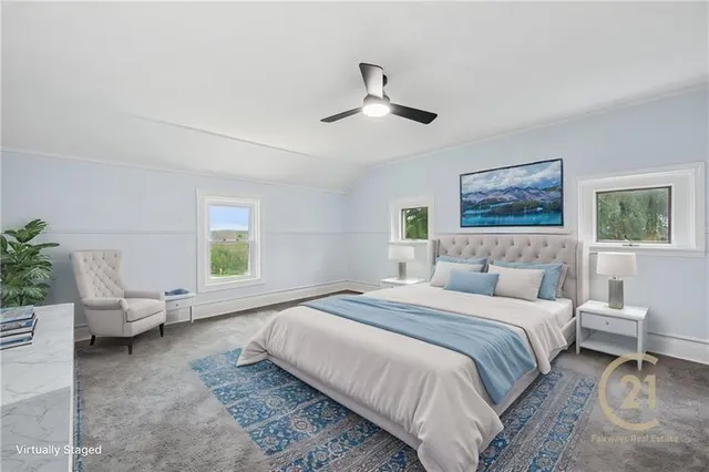 a spacious bedroom with a bed couch and a window