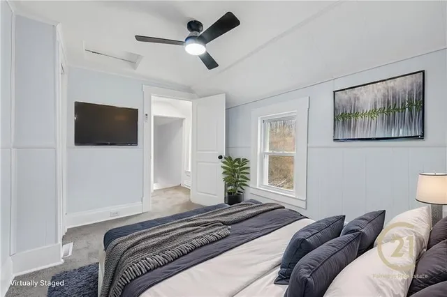 a bedroom with a bed furniture and a flat screen tv