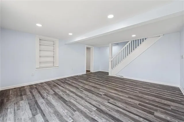 a view of a room with wooden floor and stairs