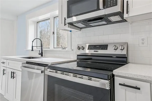 a kitchen with a stove and a sink