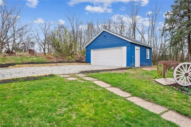 a view of a wooden bench sitting in a yard with wooden fence