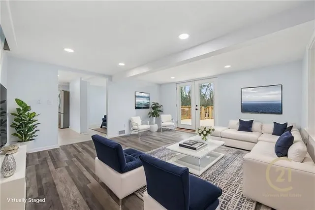 a living room with kitchen island furniture and a wooden floor