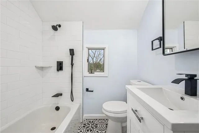 a white toilet sitting next to a bathroom sink