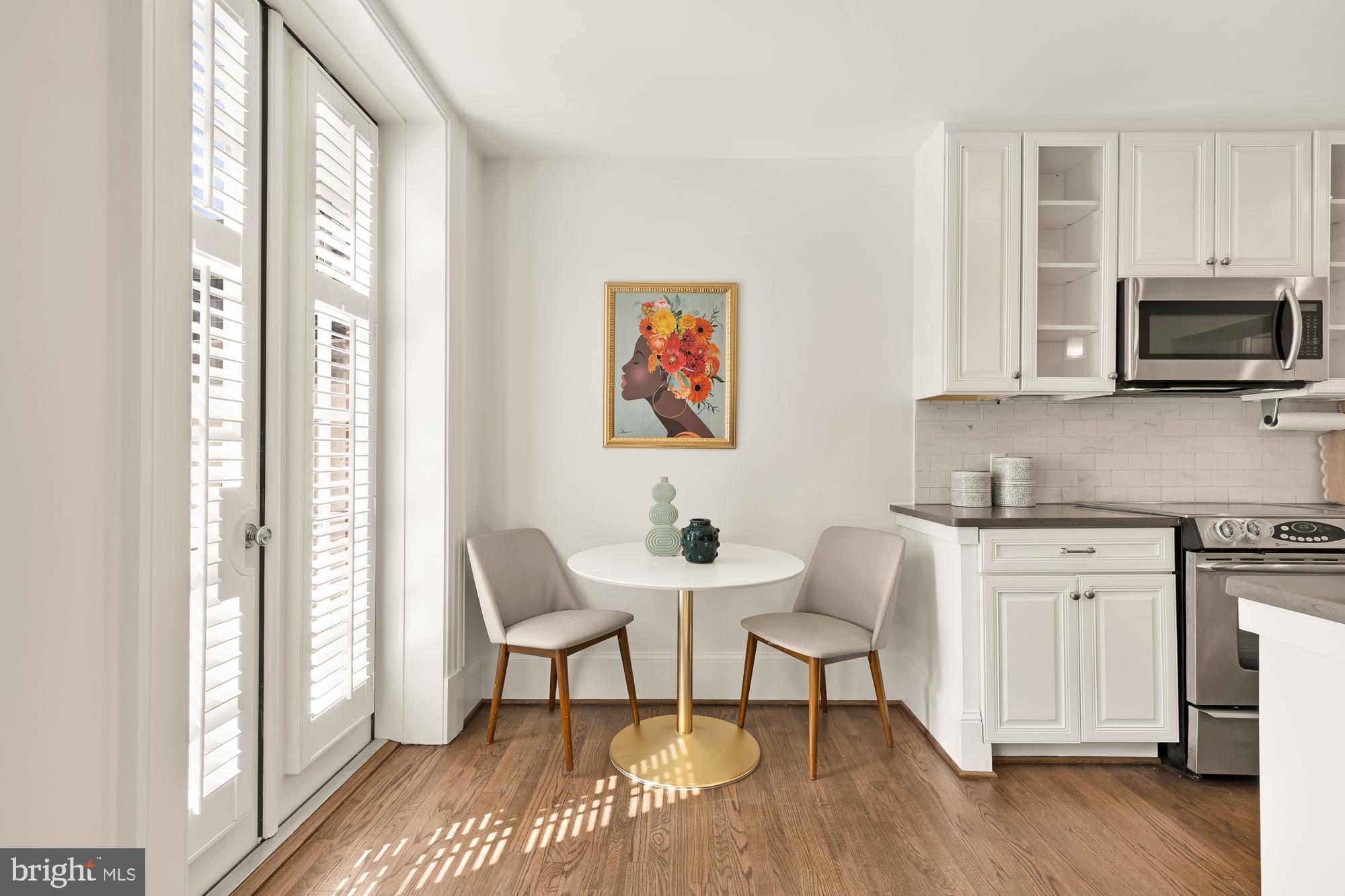 3324 18th Street Northwest, Unit 6 Washington, DC 20010 - Photo 12 of 24 a kitchen with stainless steel appliances granite countertop a stove a sink and a microwave