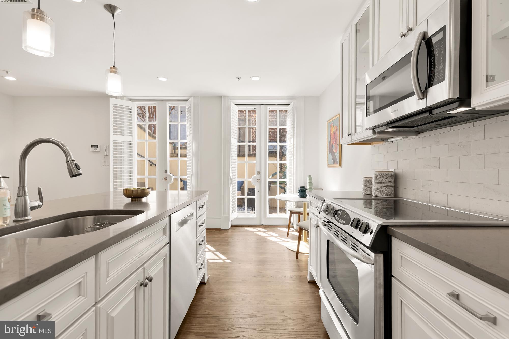 3324 18th Street Northwest, Unit 6 Washington, DC 20010 - Photo 10 of 24 a kitchen with stainless steel appliances granite countertop a sink stove and cabinets