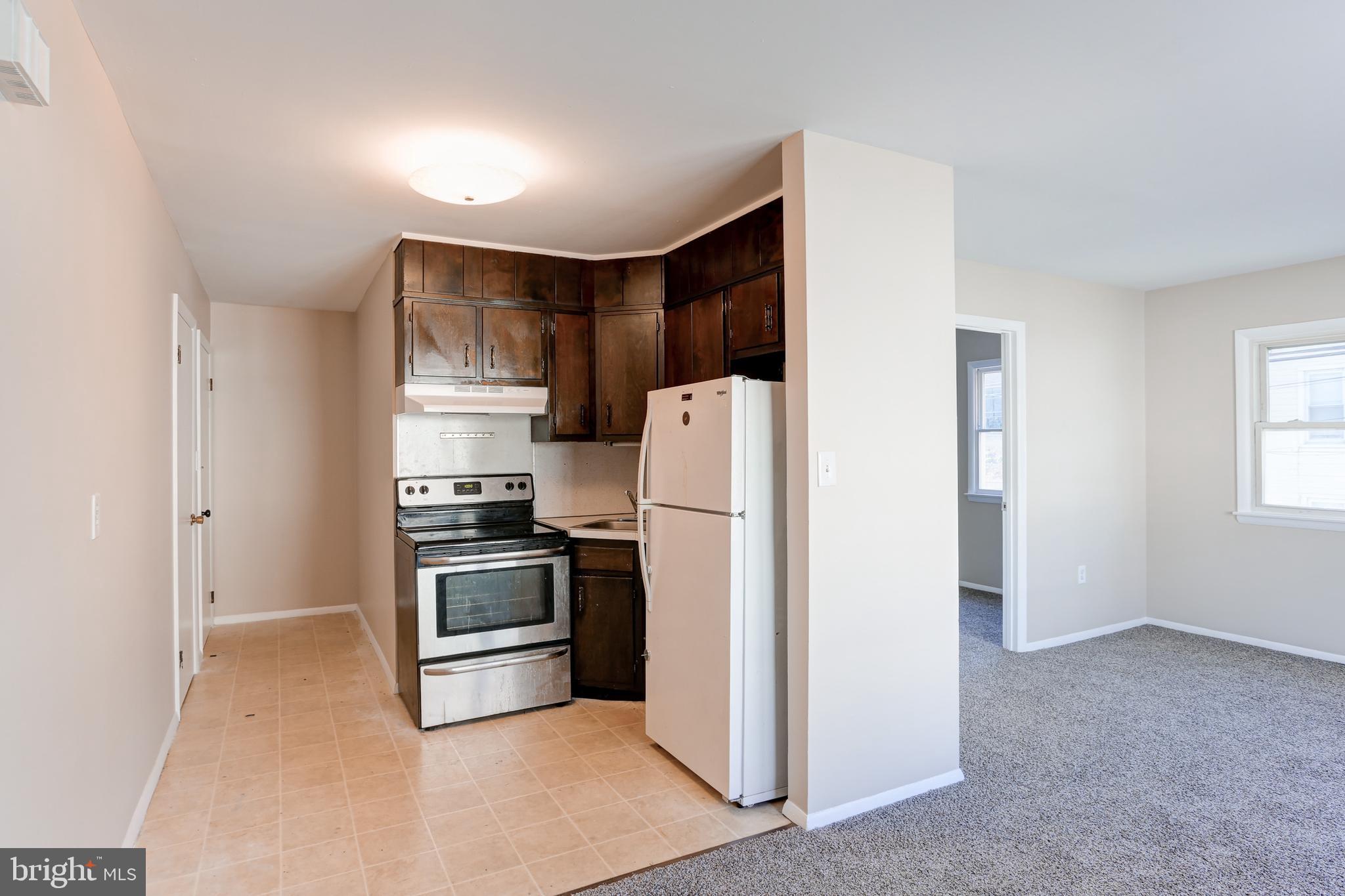11 Poplar Street, Unit 2 Wormleysburg, PA 17043 - Photo 2 of 5 a kitchen with stainless steel appliances a refrigerator and a stove top oven