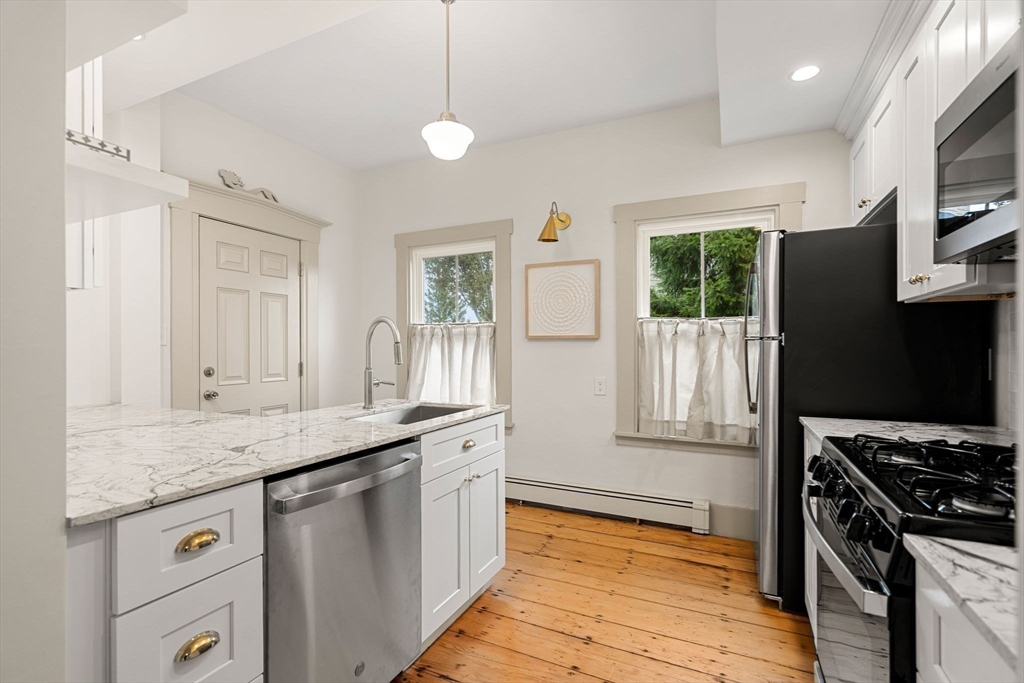 a kitchen with granite countertop a sink and a stove