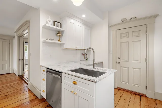a kitchen with stainless steel appliances granite countertop a sink and a refrigerator