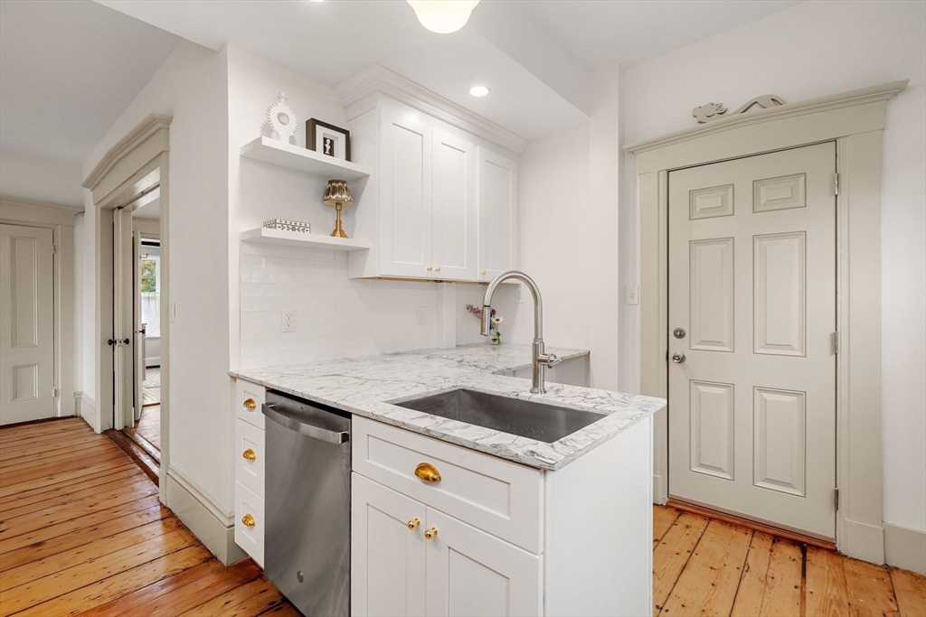 6 Mt Vernon Street, Unit 1 Marblehead, MA 01945 - Photo 3 of 14 a kitchen with stainless steel appliances granite countertop a sink and a refrigerator