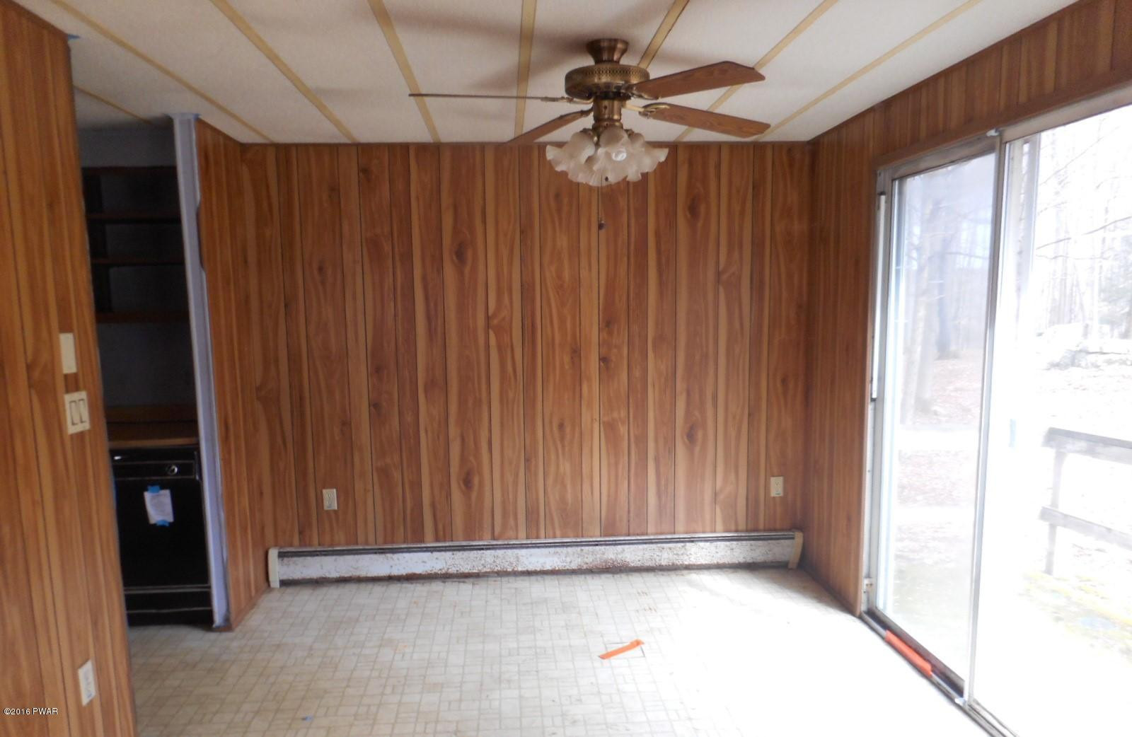 544 Hummingbird Lane Hawley, PA 18428 - Photo 8 of 16 an empty room with a windows and a ceiling fan