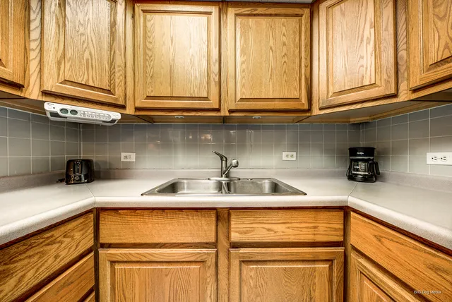 a view of a kitchen with a dining table and chairs