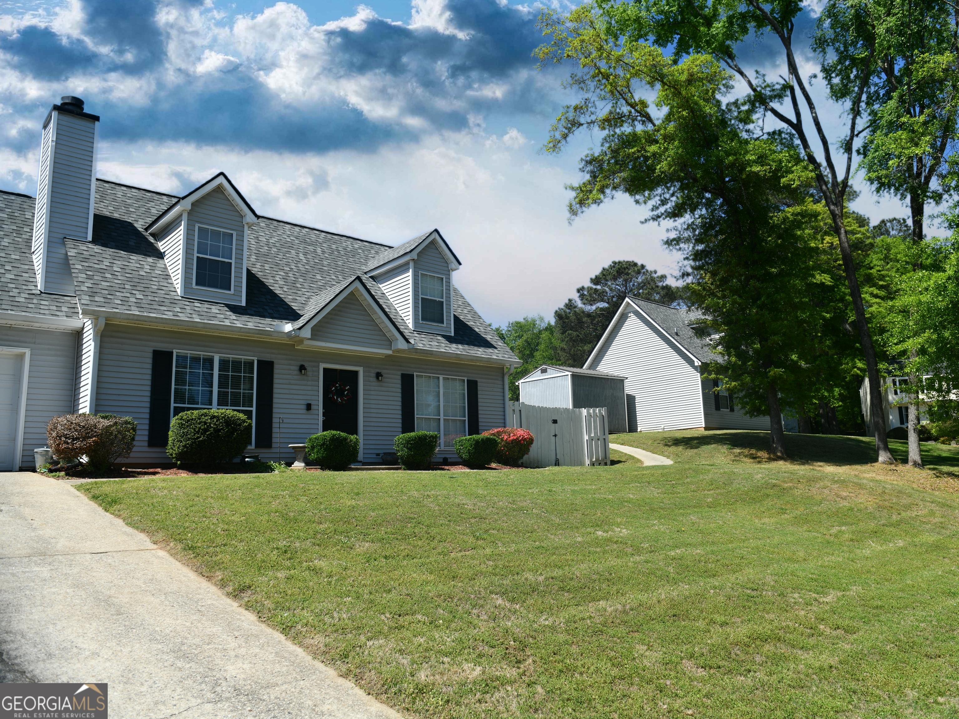 108 Sweetgum Road Peachtree City, GA 30269 - Photo 3 of 6 a view of a house with a big yard and large trees
