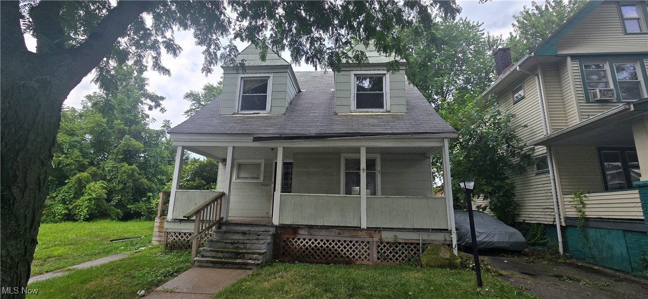 445 Cleveland Road Cleveland, OH 44108 - Photo 1 of 10 View of front of property with a porch, a front lawn, and a shingled roof