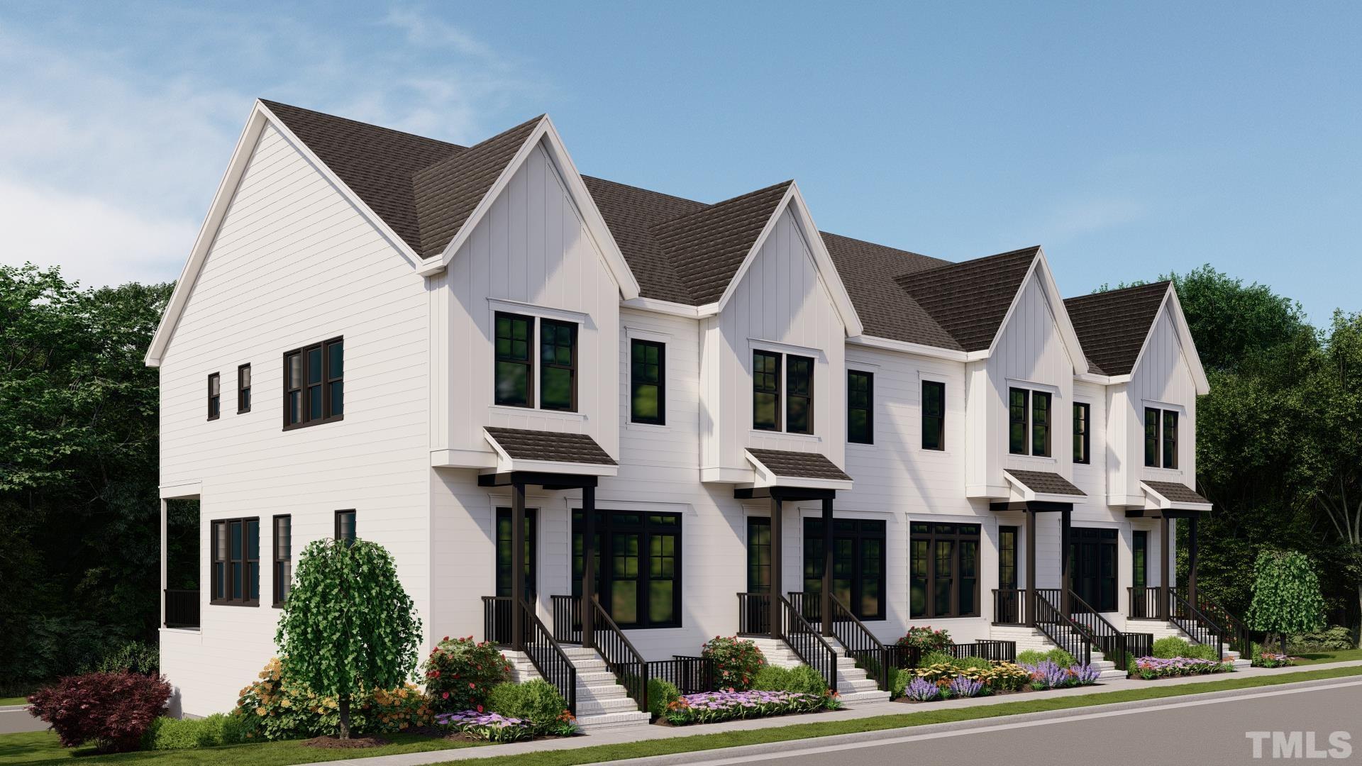 a view of a white house with large windows and a small yard