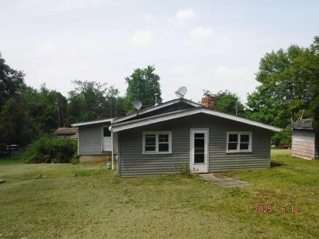 a backyard of a house with large trees