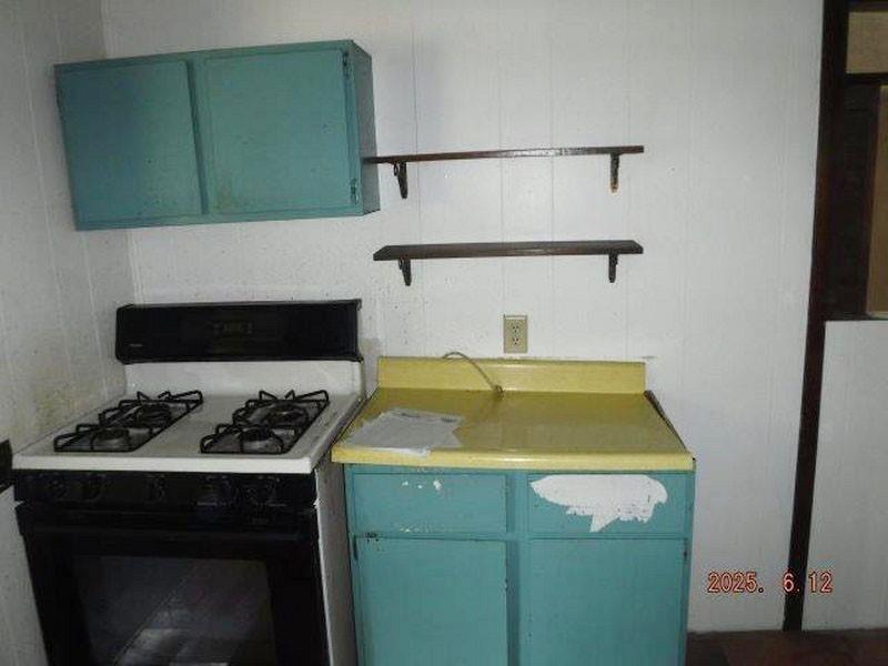 822 Robin Road Saltsburg, PA 15681 - Photo 3 of 8 a bathroom with a sink and a stove