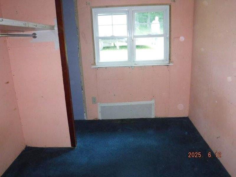 822 Robin Road Saltsburg, PA 15681 - Photo 4 of 8 an empty room with wooden floor and windows